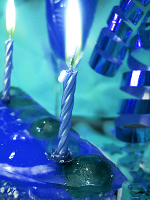 cake and candles on green background